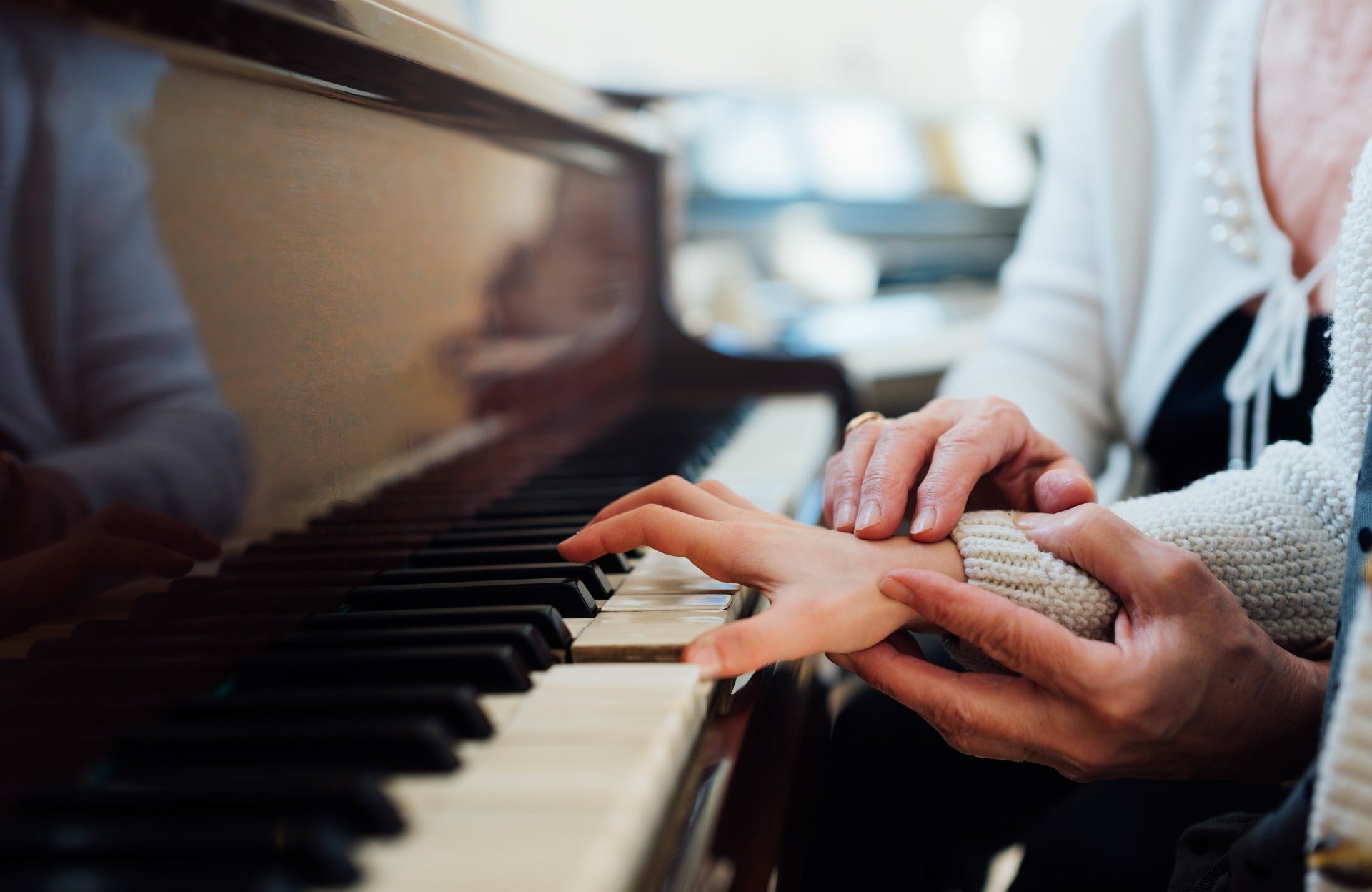 Piano technician and pianist at an acoustic piano